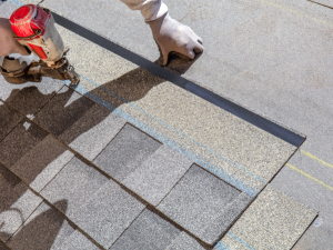 a roofer installs new roofing shingles on a Fairfax, VA, home