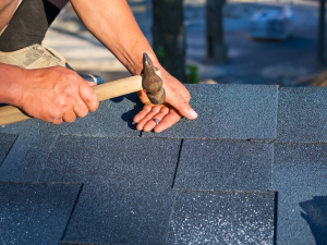 A homeowner performing DIY roofing work in Springfield. Call a contractor for professional help!