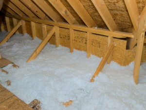 Insulated and well-ventilated attic space to prevent ice dams, demonstrated by a Lorton roofing expert.